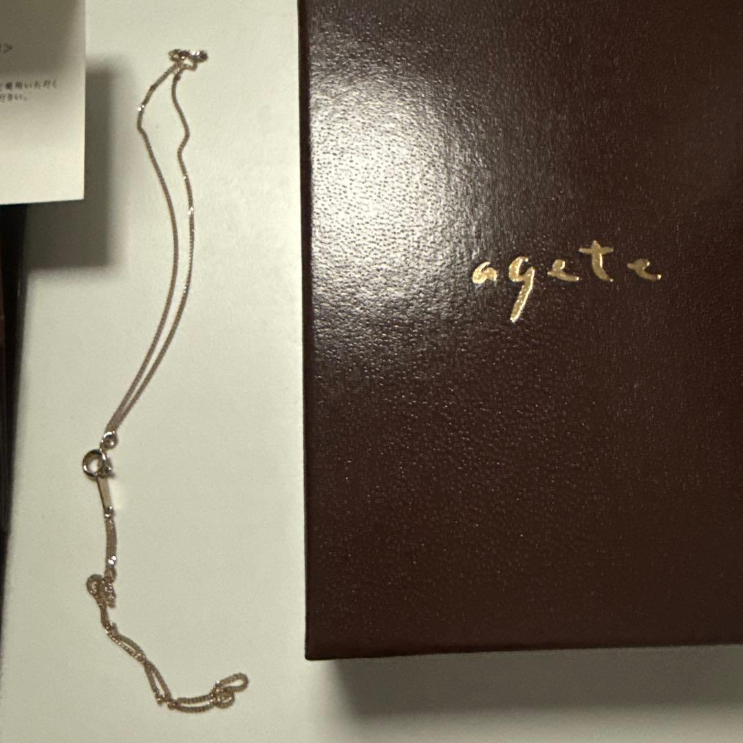 Agete necklace featuring labradorite and onyx stones with silver bottle-shaped pendant and charm
