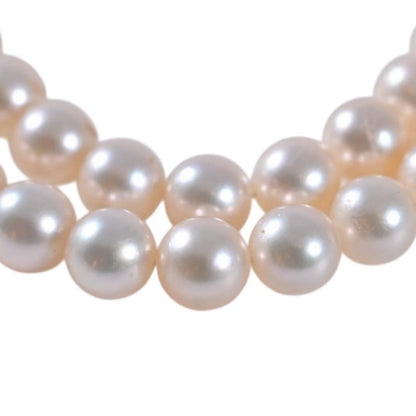 Highest-grade Mikimoto K14 Akoya pearl necklace with 7mm round pearls and white gold clasp on a white background