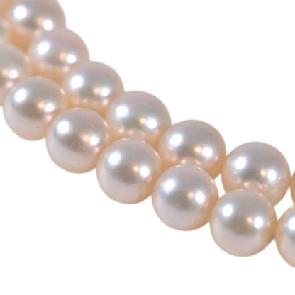 Highest-grade Mikimoto K14 Akoya pearl necklace with 7mm round pearls and white gold clasp on a white background