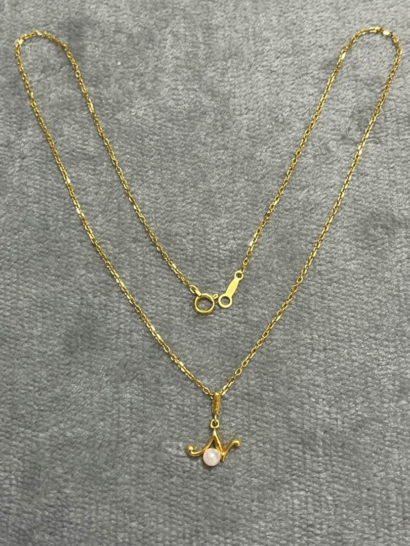 MIKIMOTO pearl necklace featuring 18k gold pendant, 38.5cm long, displayed on white background