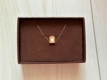 Pink K10 gold necklace featuring a delicate agate conch shell pendant