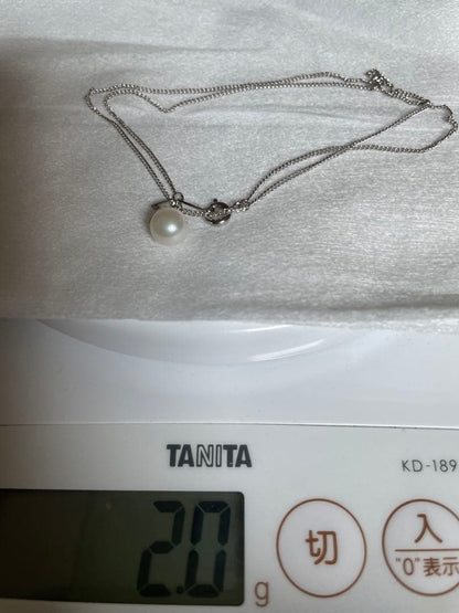 Close-up of 7mm Akoya pearl necklace pendant in 14K white gold on white background