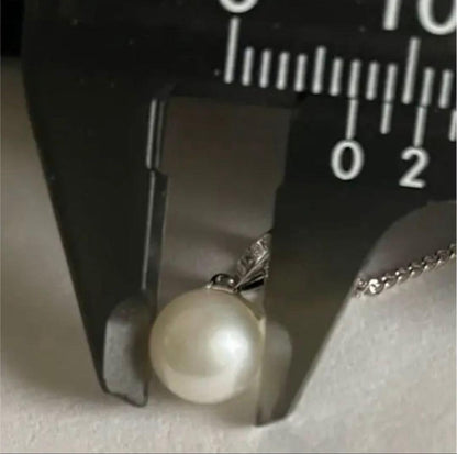 Close-up of 7mm Akoya pearl necklace pendant in 14K white gold on white background