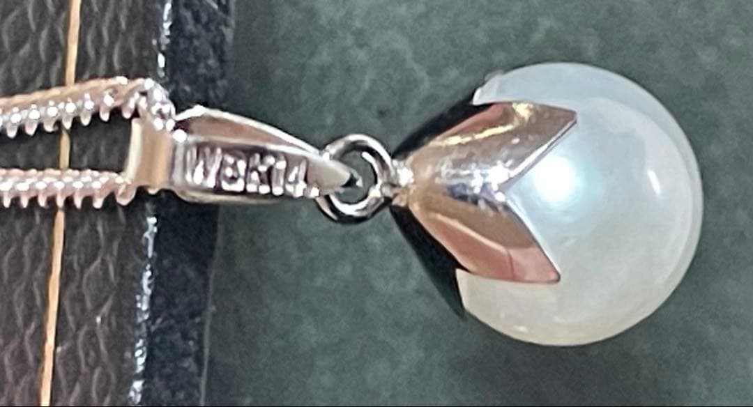 Close-up of 7mm Akoya pearl necklace pendant in 14K white gold on white background