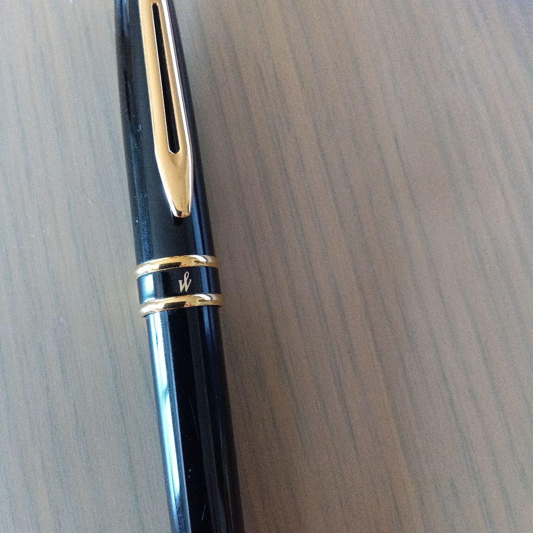 Waterman black ballpoint pen with gold metal fittings and plastic body displayed with dedicated case