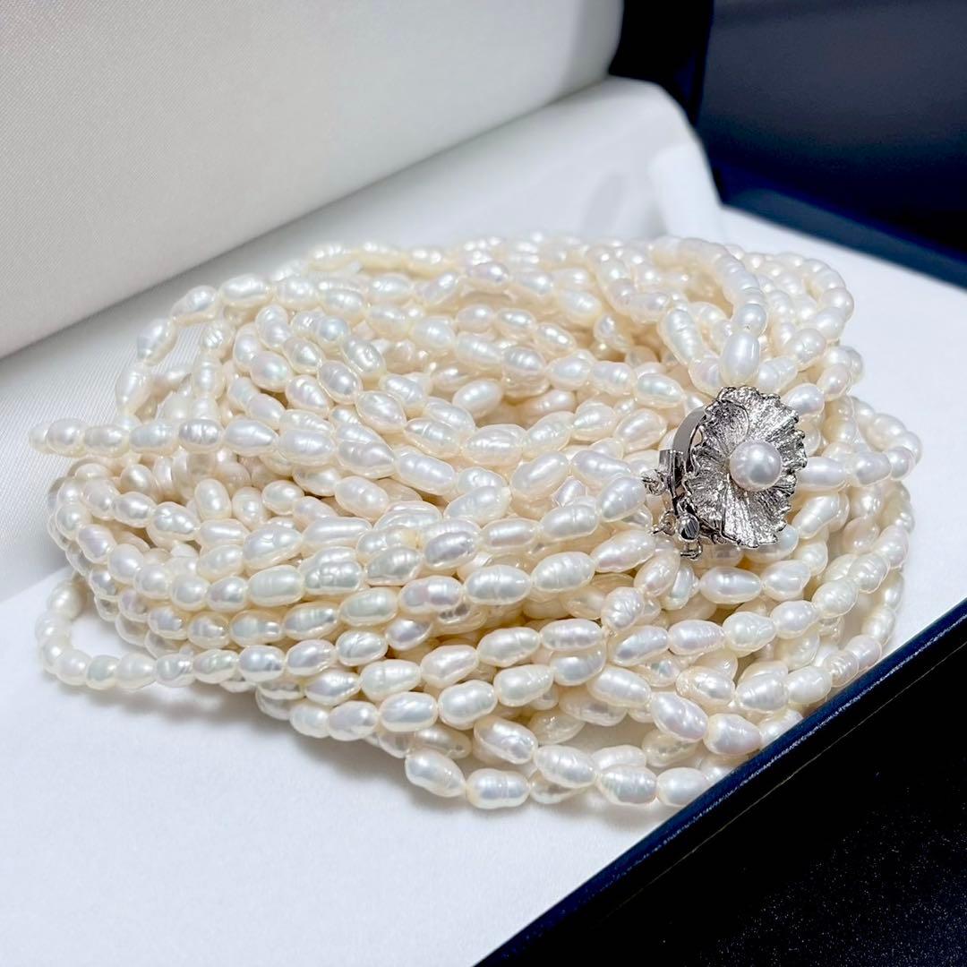 Akoya pearl 8-strand necklace with silver clasp displayed on a white background