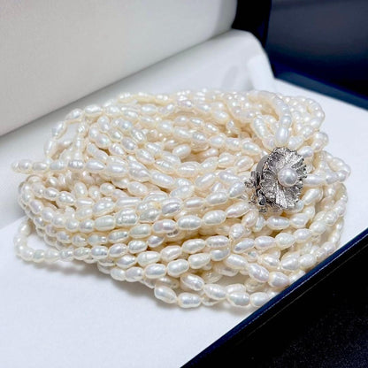 Akoya pearl 8-strand necklace with silver clasp displayed on a white background