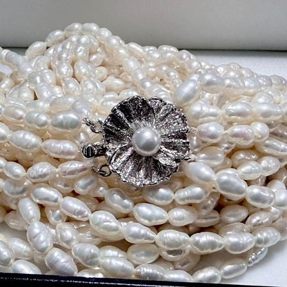Akoya pearl 8-strand necklace with silver clasp displayed on a white background
