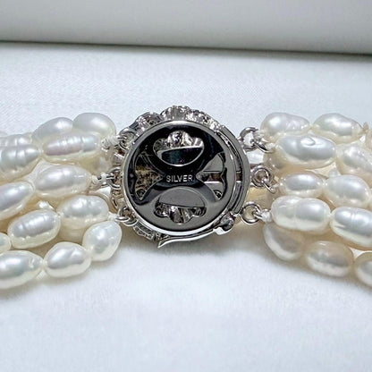 Akoya pearl 8-strand necklace with silver clasp displayed on a white background