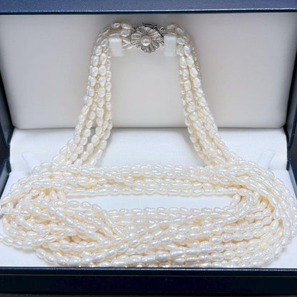 Akoya pearl 8-strand necklace with silver clasp displayed on a white background
