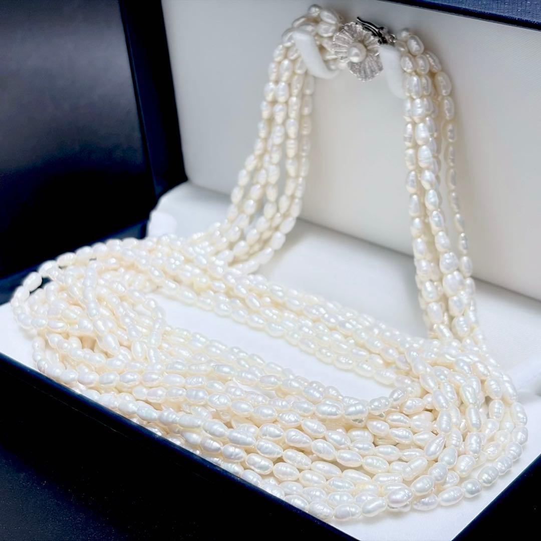Akoya pearl 8-strand necklace with silver clasp displayed on a white background