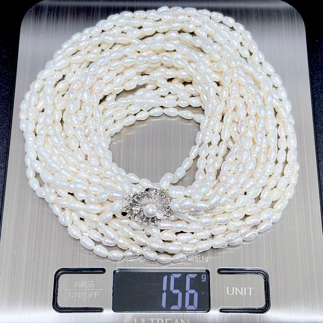Akoya pearl 8-strand necklace with silver clasp displayed on a white background