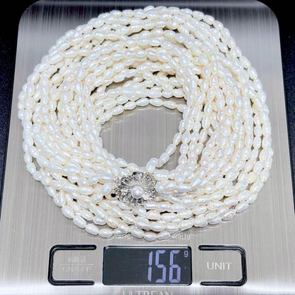 Akoya pearl 8-strand necklace with silver clasp displayed on a white background