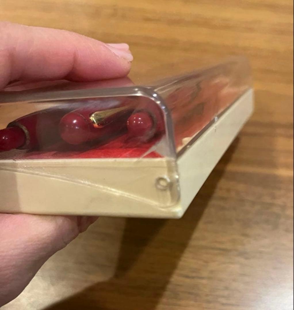 Pilot ballpoint pen mechanical pencil and fountain pen set in red and gold cracked case, showing wear and rust
