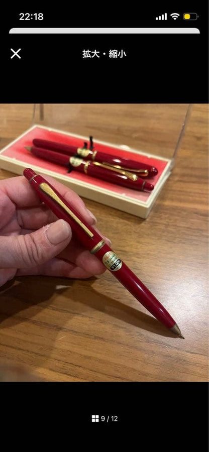 Pilot ballpoint pen mechanical pencil and fountain pen set in red and gold cracked case, showing wear and rust