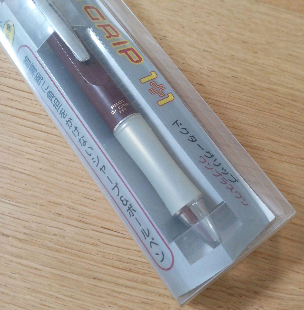 Pilot Dr. Grip 1+1 multi-function pen with dark red barrel, black 0.5mm ballpoint tip, and 0.5mm mechanical pencil