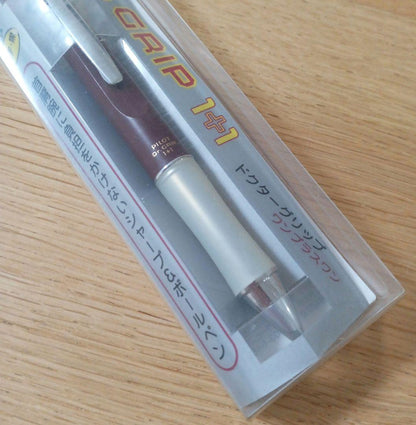 Pilot Dr. Grip 1+1 multi-function pen with dark red barrel, black 0.5mm ballpoint tip, and 0.5mm mechanical pencil