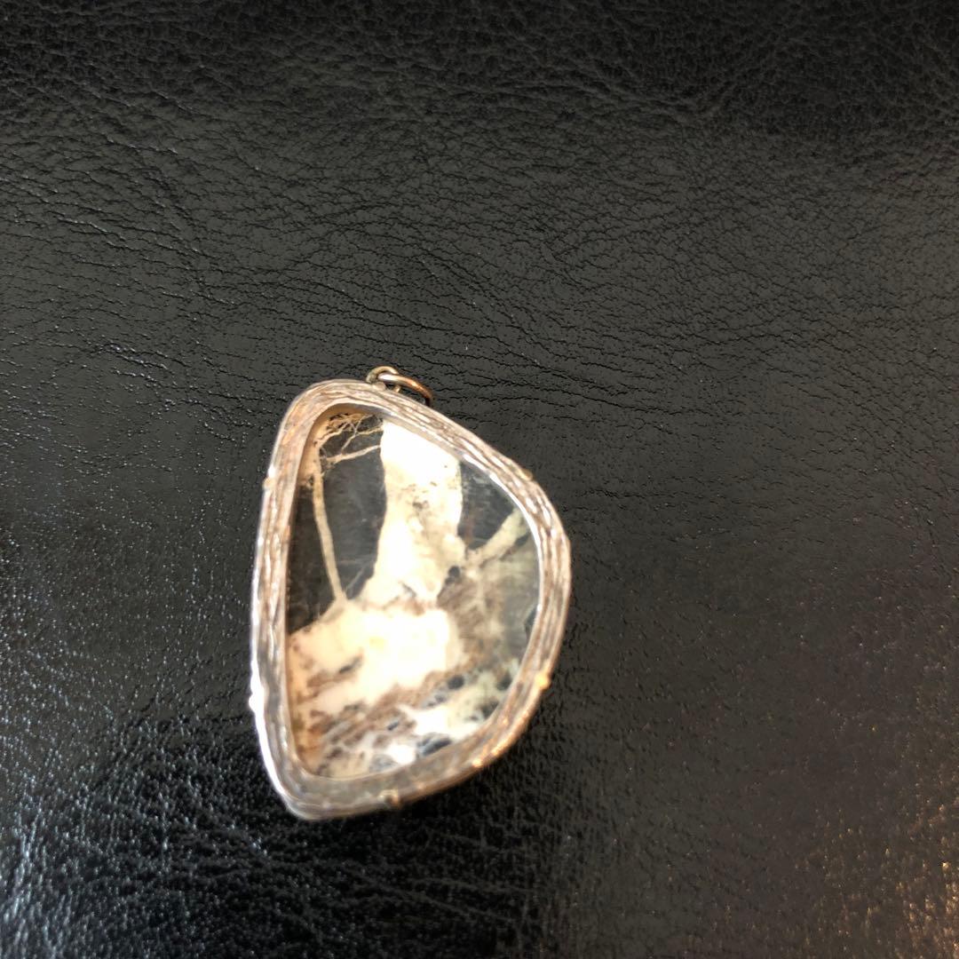 Agete Pendant Head made of stone with unique pattern shown on a chain