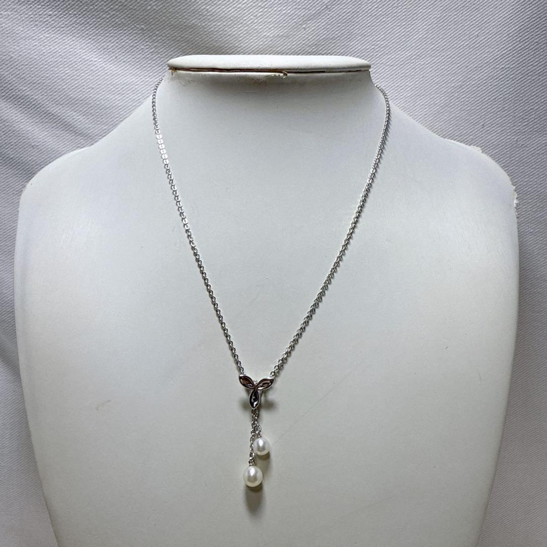 Tasaki silver necklace featuring two moving Akoya pearls on a 40 cm metal chain