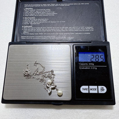 Tasaki silver necklace featuring two moving Akoya pearls on a 40 cm metal chain