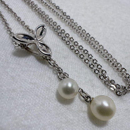 Tasaki silver necklace featuring two moving Akoya pearls on a 40 cm metal chain
