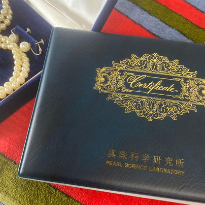 Akoya pearl necklace, matching earrings, and bracelet displayed on a white background