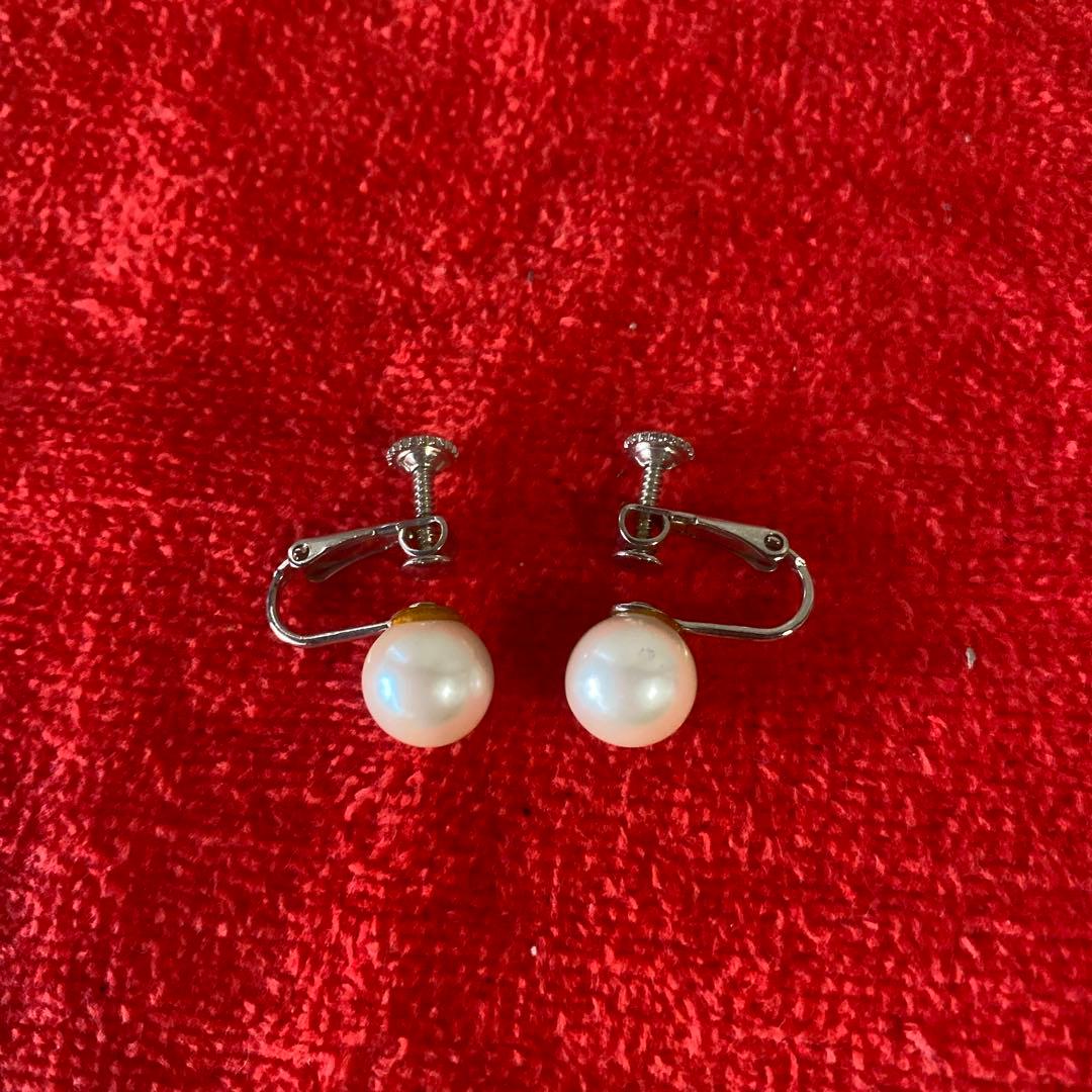 Akoya pearl necklace, matching earrings, and bracelet displayed on a white background