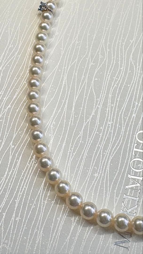 Mikimoto pearl necklace featuring 71 Akoya pearls sized 6.5 to 6.0mm with silver clasp and M logo charm
