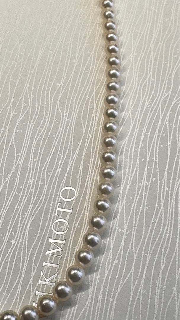 Mikimoto pearl necklace featuring 71 Akoya pearls sized 6.5 to 6.0mm with silver clasp and M logo charm