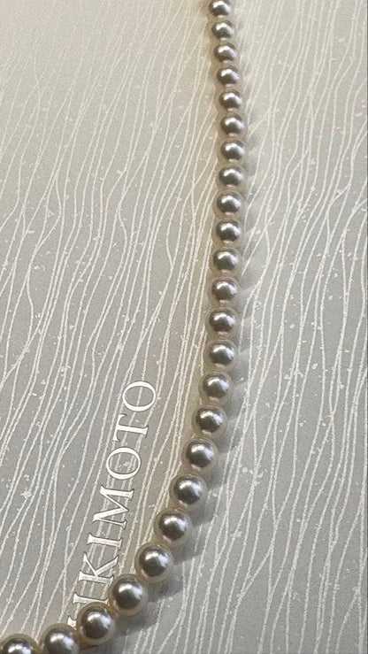 Mikimoto pearl necklace featuring 71 Akoya pearls sized 6.5 to 6.0mm with silver clasp and M logo charm