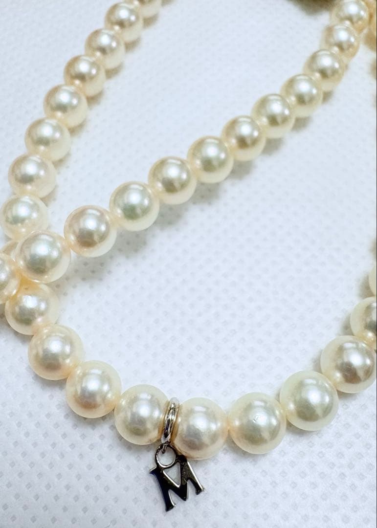 Mikimoto pearl necklace featuring 71 Akoya pearls sized 6.5 to 6.0mm with silver clasp and M logo charm
