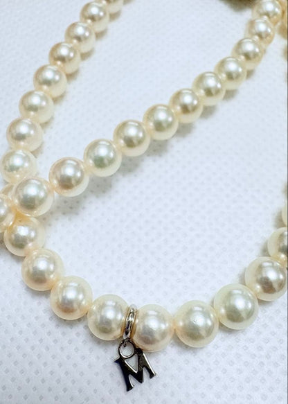 Mikimoto pearl necklace featuring 71 Akoya pearls sized 6.5 to 6.0mm with silver clasp and M logo charm