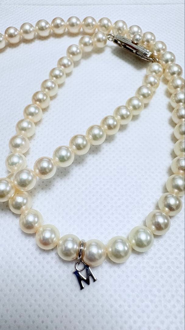 Mikimoto pearl necklace featuring 71 Akoya pearls sized 6.5 to 6.0mm with silver clasp and M logo charm