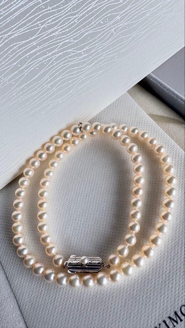 Mikimoto pearl necklace featuring 71 Akoya pearls sized 6.5 to 6.0mm with silver clasp and M logo charm