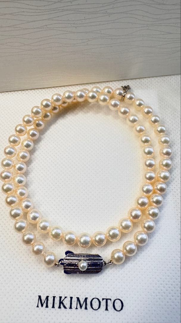 Mikimoto pearl necklace featuring 71 Akoya pearls sized 6.5 to 6.0mm with silver clasp and M logo charm