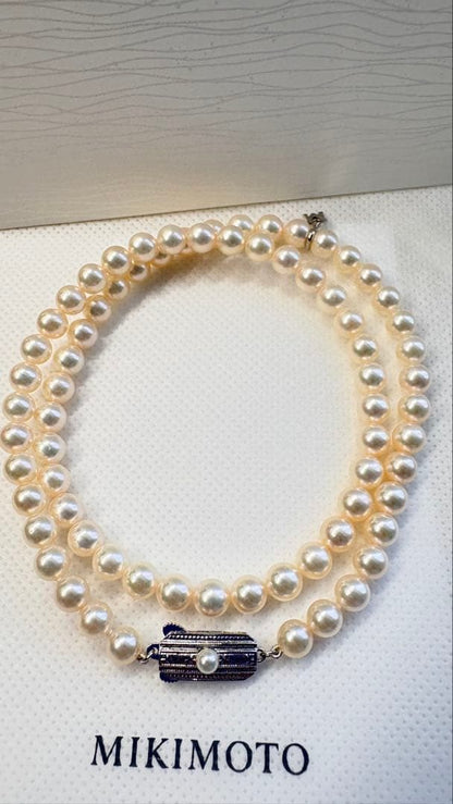 Mikimoto pearl necklace featuring 71 Akoya pearls sized 6.5 to 6.0mm with silver clasp and M logo charm
