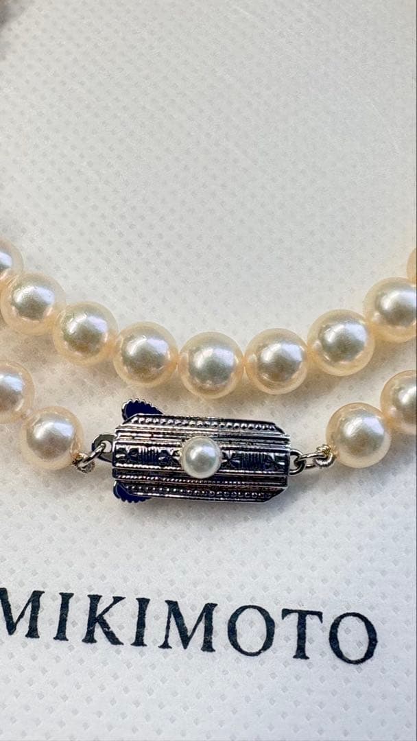 Mikimoto pearl necklace featuring 71 Akoya pearls sized 6.5 to 6.0mm with silver clasp and M logo charm