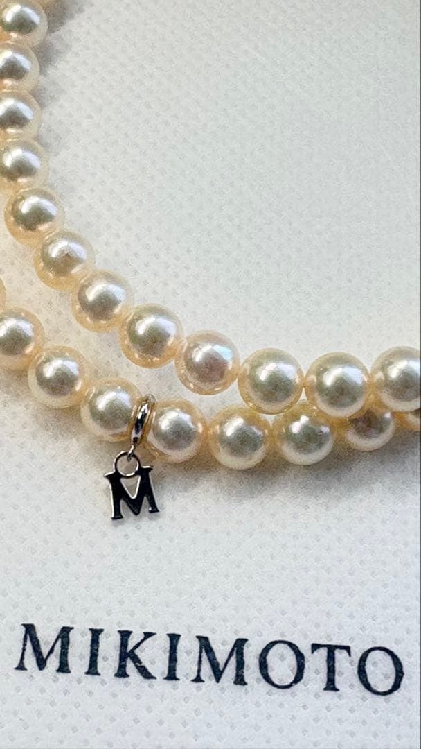 Mikimoto pearl necklace featuring 71 Akoya pearls sized 6.5 to 6.0mm with silver clasp and M logo charm