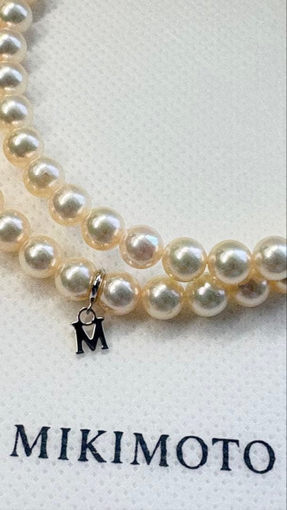 Mikimoto pearl necklace featuring 71 Akoya pearls sized 6.5 to 6.0mm with silver clasp and M logo charm