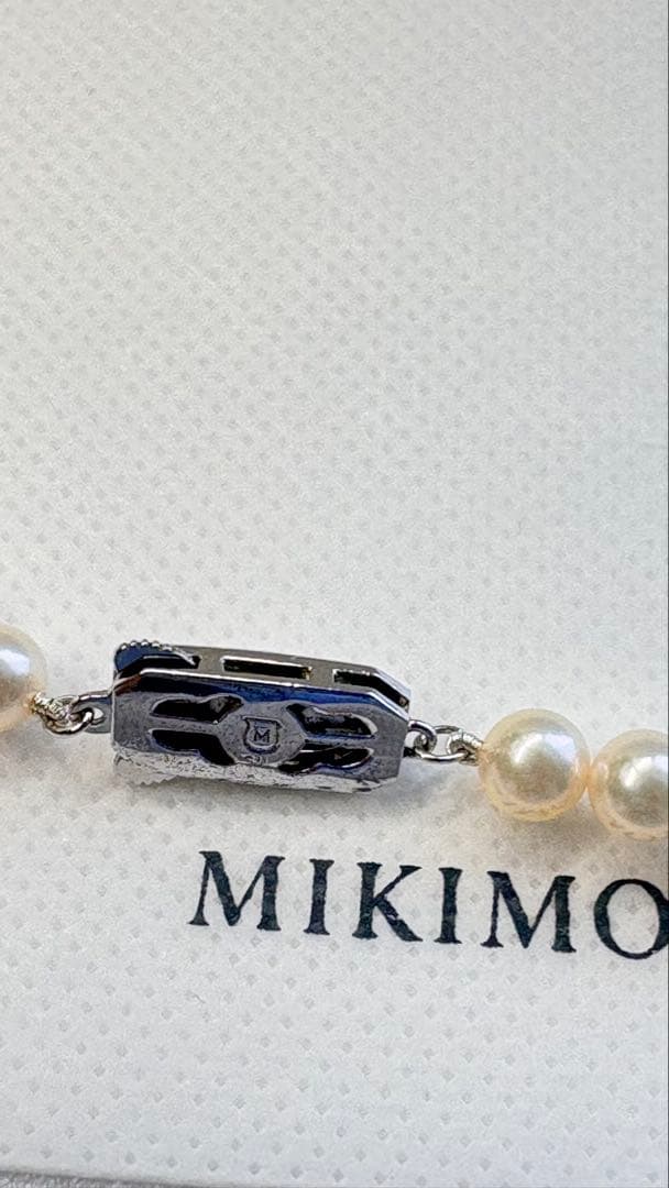 Mikimoto pearl necklace featuring 71 Akoya pearls sized 6.5 to 6.0mm with silver clasp and M logo charm
