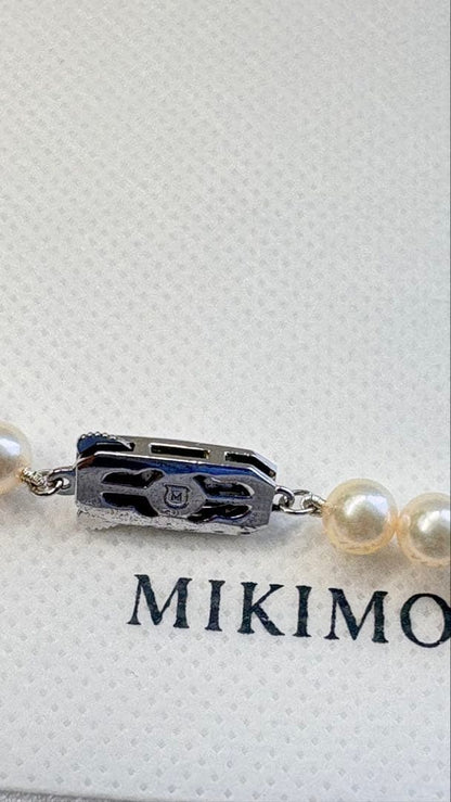 Mikimoto pearl necklace featuring 71 Akoya pearls sized 6.5 to 6.0mm with silver clasp and M logo charm