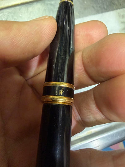 Waterman Paris black gold fountain pen with sleek design and gold accents on a white background