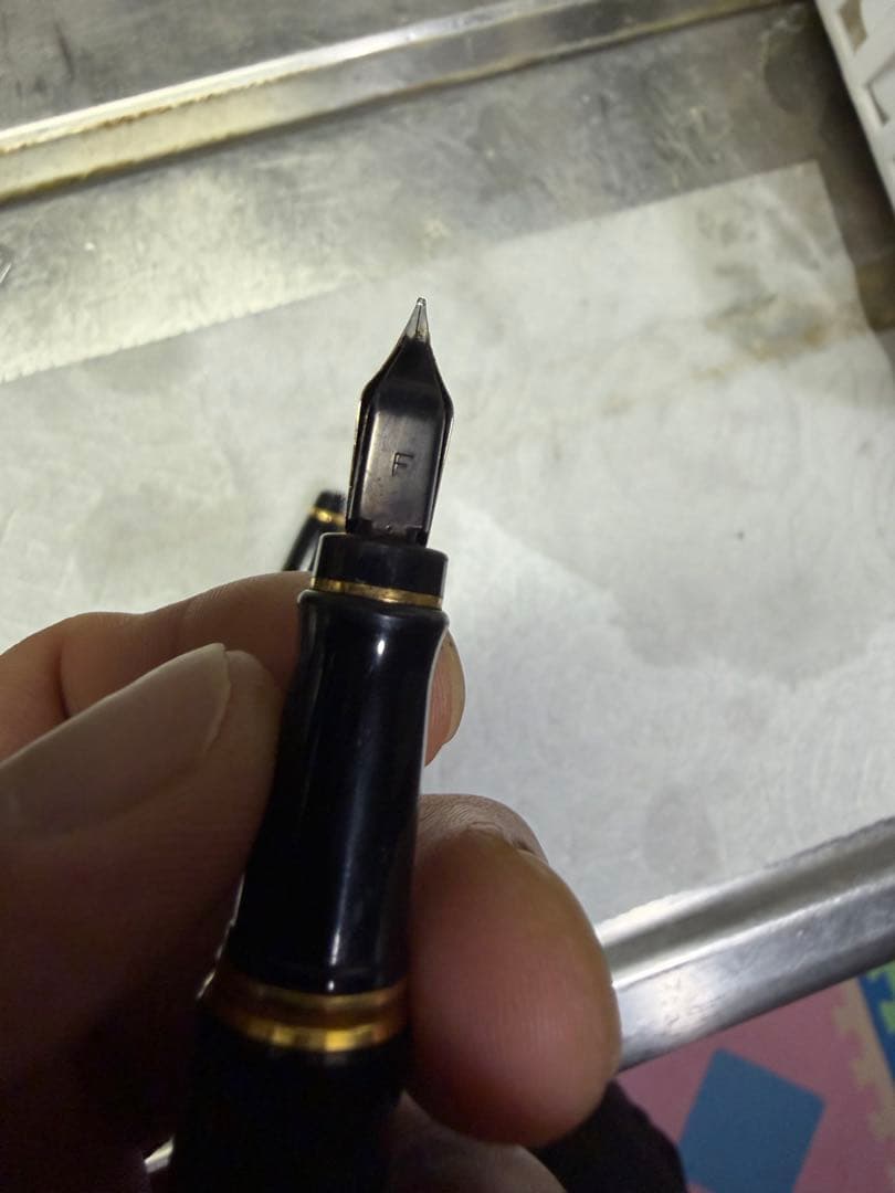 Waterman Paris black gold fountain pen with sleek design and gold accents on a white background