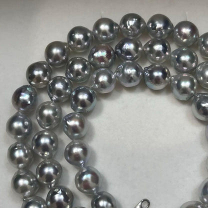 18K gold long necklace with 9mm Akoya blue pearls, 63cm length, weighing 59 grams
