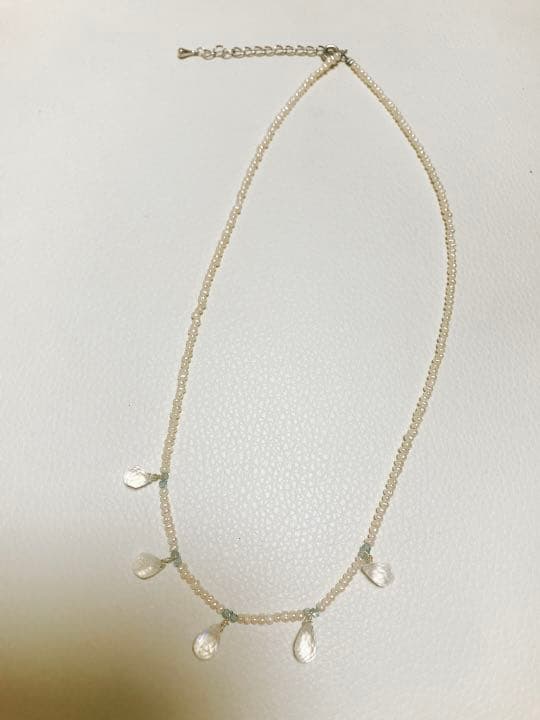 Milky Quartz necklace with aquamarine and freshwater pearl stones on a white background