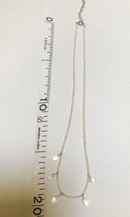 Milky Quartz necklace with aquamarine and freshwater pearl stones on a white background