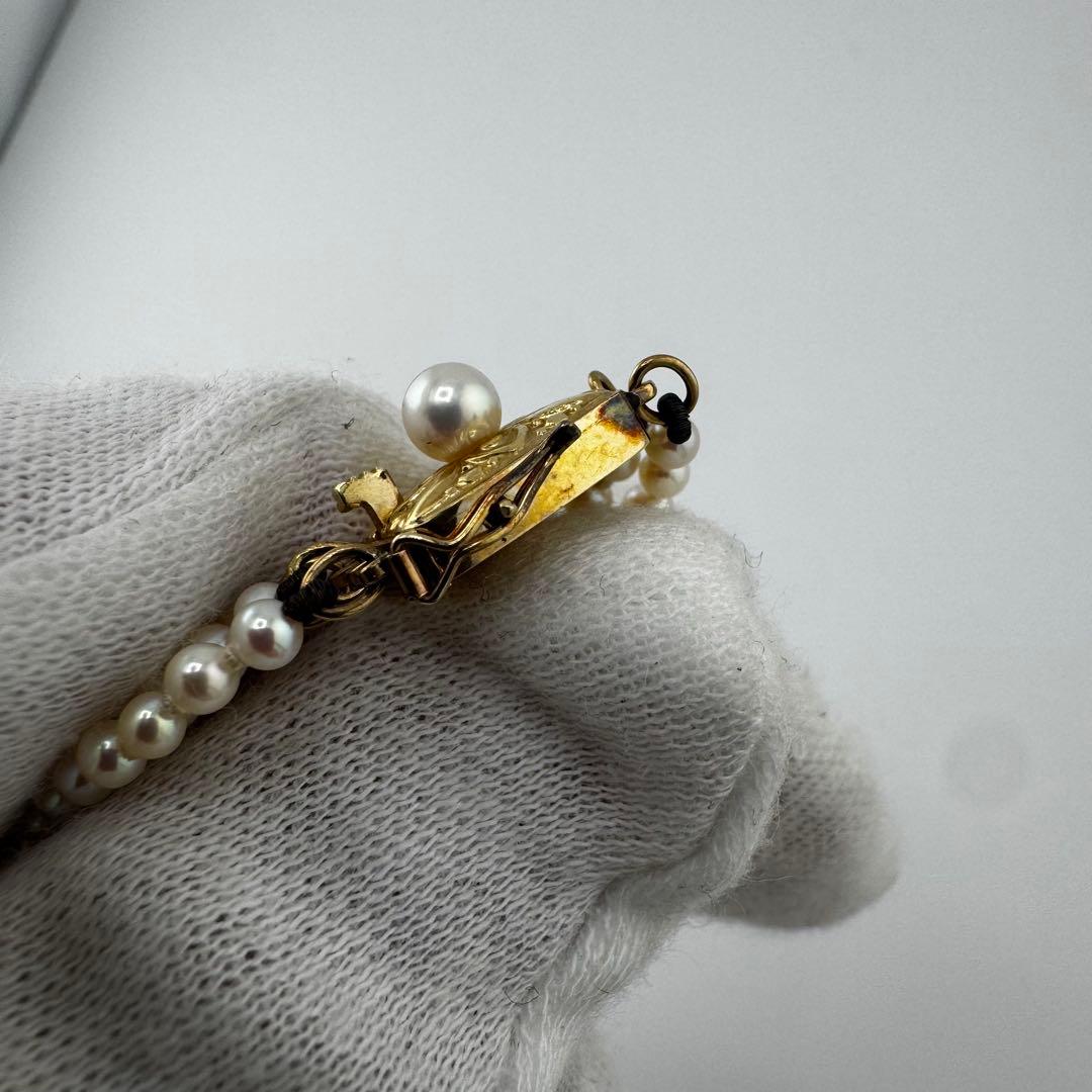 Law Mikimoto K14 yellow gold necklace with three rows of small 2.8mm Akoya baby pearls and Mikimoto clasp