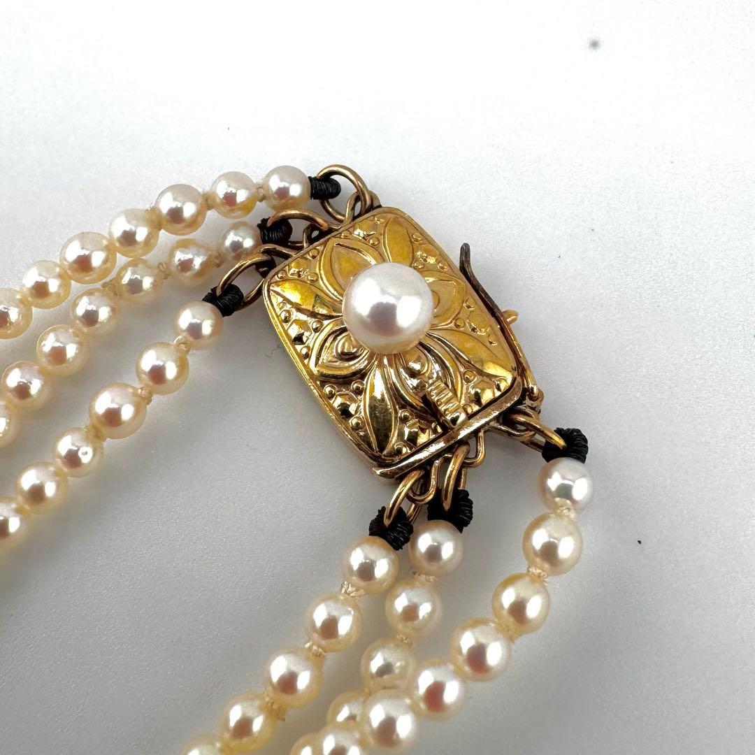 Law Mikimoto K14 yellow gold necklace with three rows of small 2.8mm Akoya baby pearls and Mikimoto clasp