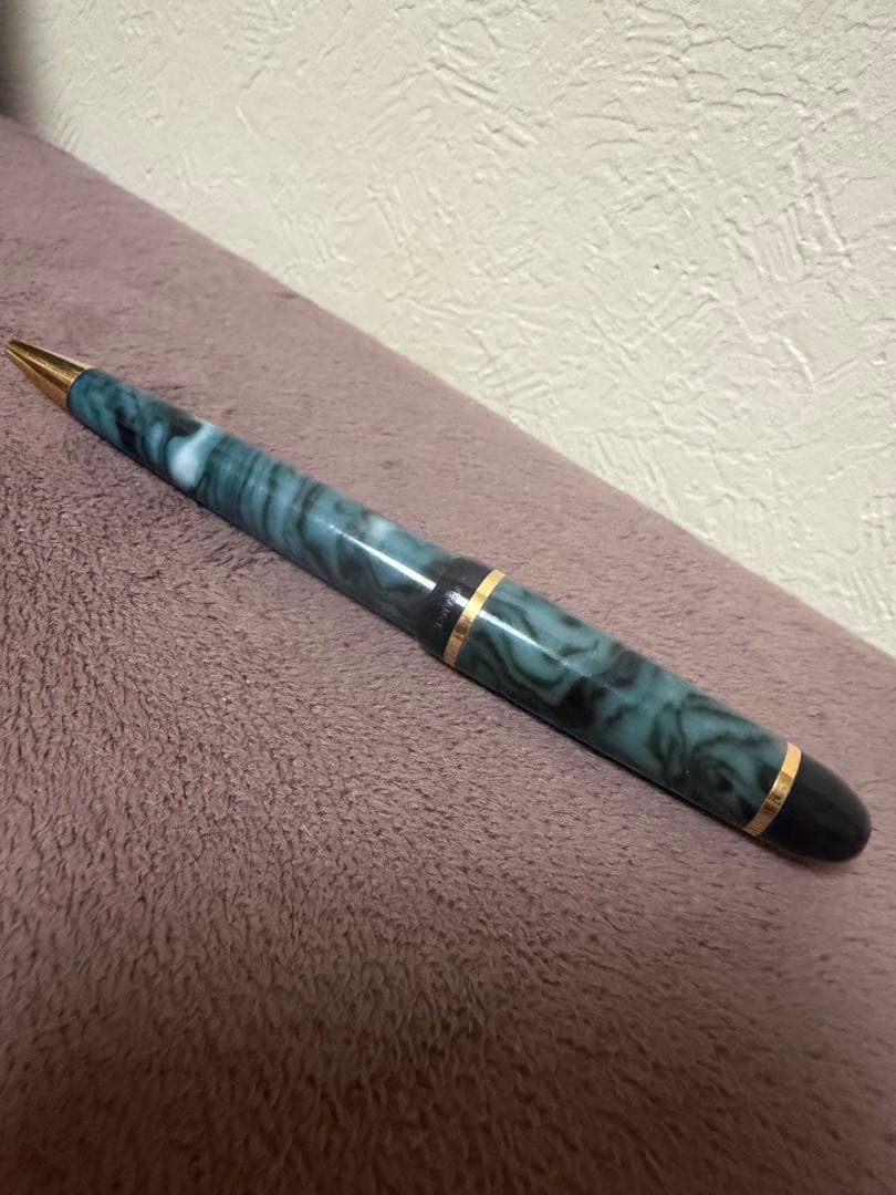 Waterman ballpoint pen in marble blue with gold trim lying horizontally on white background