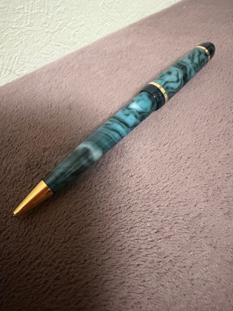 Waterman ballpoint pen in marble blue with gold trim lying horizontally on white background